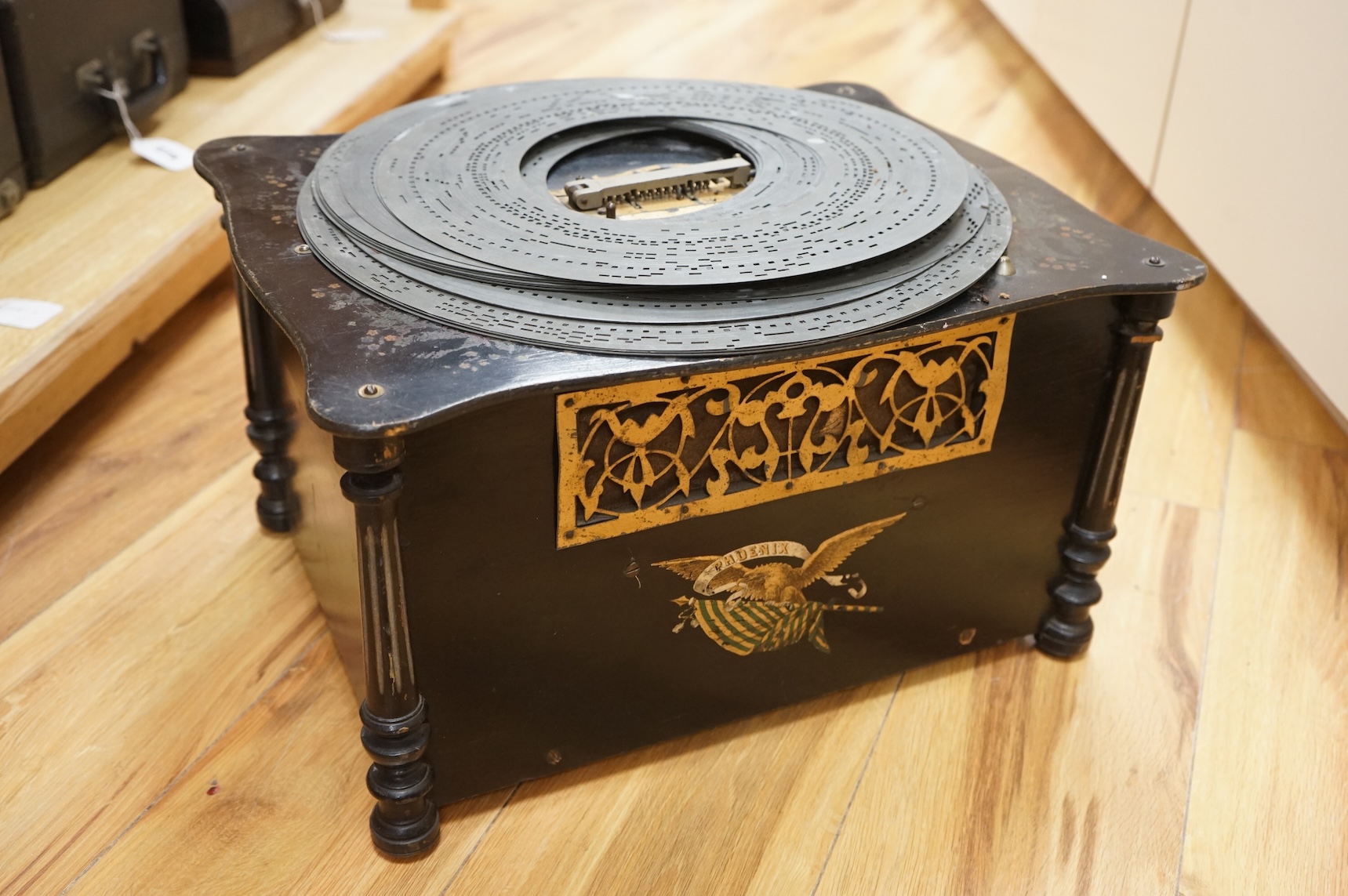 An early 20th century Organette Phoenix in an ebonised case, together with a selection of nineteen related and unrelated discs in three different sizes; five 37cm diameter discs, three 33.3cm diameter discs and eleven 31